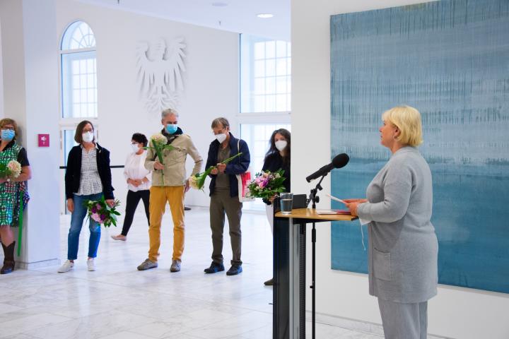 Landtagspräsidentin Prof. Dr. Ulrike Liedtke (r.) bedankt sich bei den Künstlerinnen und Künstlern