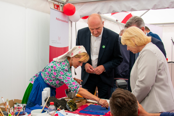 Landtagspräsidentin Prof. Dr. Ulrike Liedtke (1. v. r.), Bürgermeister Jörg Gampe (2. v. r.) und Ministerpräsident Dr. Dietmar Woidke (3. v. r.) erfuhren beim Rat für die Angelegenheiten der Sorben/Wenden mehr über Blaudruck-Textilien.