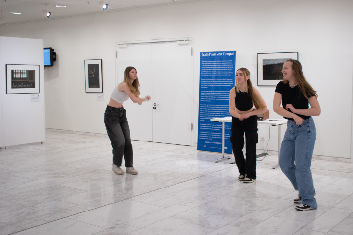 Tänzerische Interventionen in der Ausstellung mit Schülerinnen des Friedrich-Gymnasiums Luckenwalde. Die Schülerinnen interagieren mit einzelnen Fotos im Ausstellungsraum.