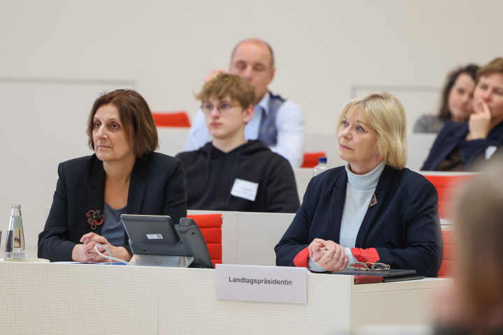Landtagspräsidentin Prof. Dr. Ulrike Liedtke (r.) und die Ministerin für Bildung, Jugend und Sport Britta Ernst (l.) folgen der Finaldebatte der Altersgruppe I
